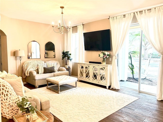 living room featuring a chandelier and wood-type flooring