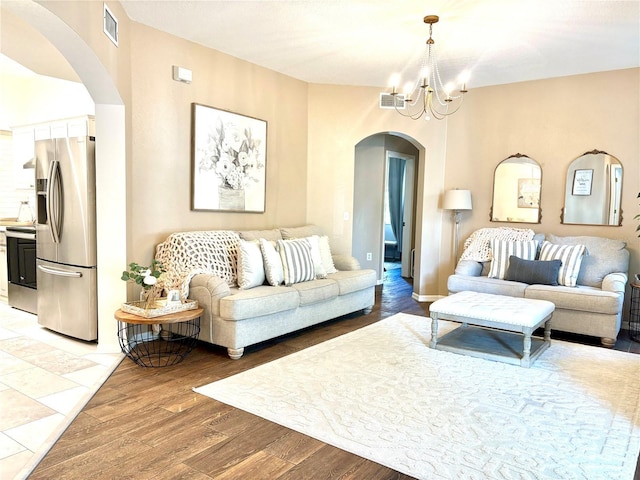 living room featuring wood-type flooring and a notable chandelier