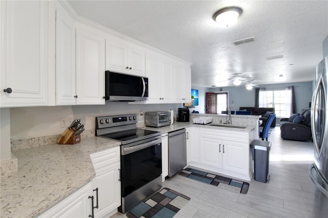 kitchen featuring white cabinetry, sink, and stainless steel appliances