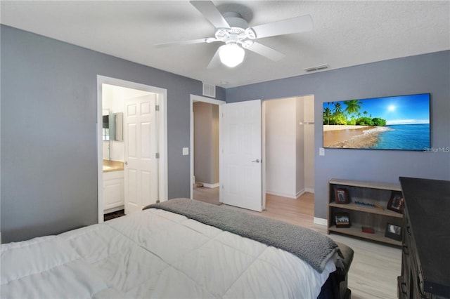 bedroom featuring ensuite bathroom, ceiling fan, and light hardwood / wood-style floors