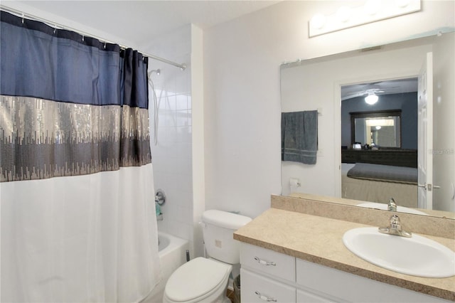 full bathroom with ceiling fan, vanity, shower / bath combo, and toilet