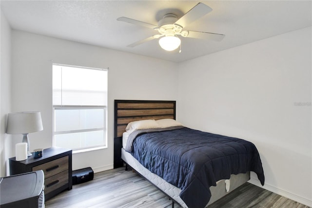 bedroom featuring ceiling fan and light hardwood / wood-style flooring