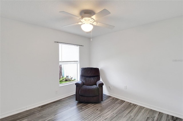 living area with ceiling fan and wood-type flooring