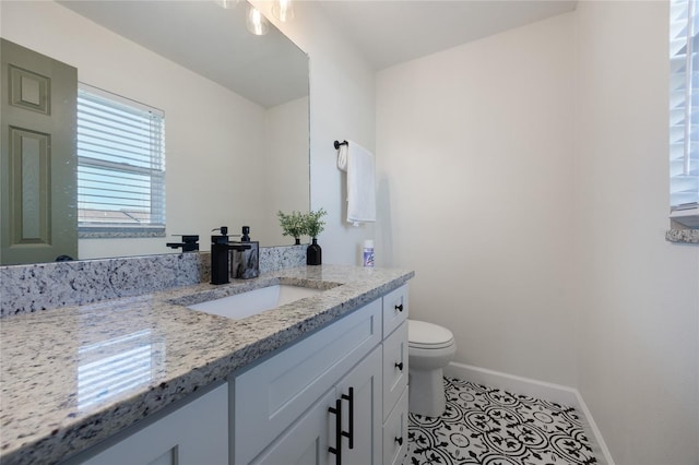 bathroom with tile patterned floors, vanity, and toilet