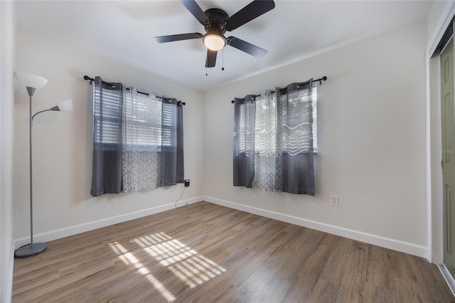 spare room featuring hardwood / wood-style floors and ceiling fan