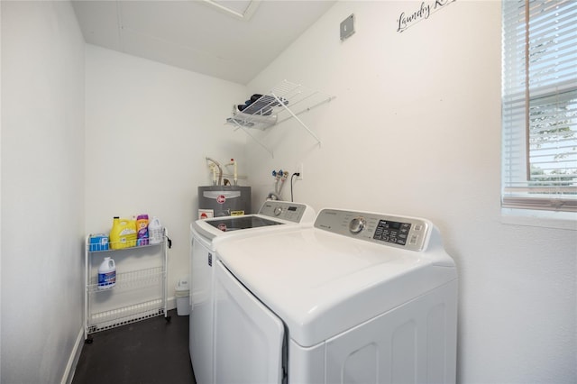 laundry room with washing machine and clothes dryer and water heater