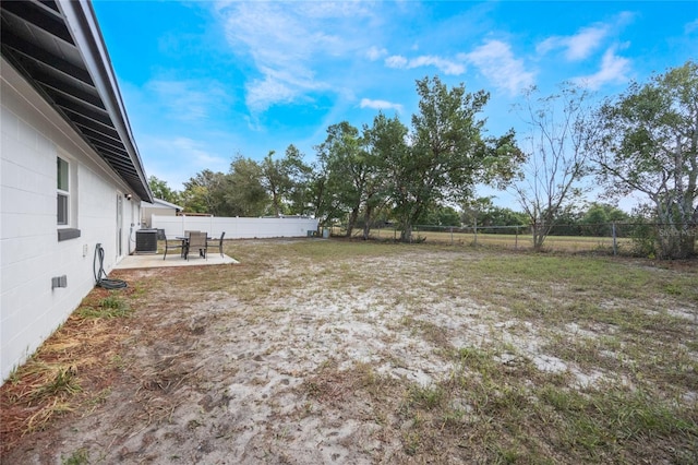 view of yard featuring a patio and central AC