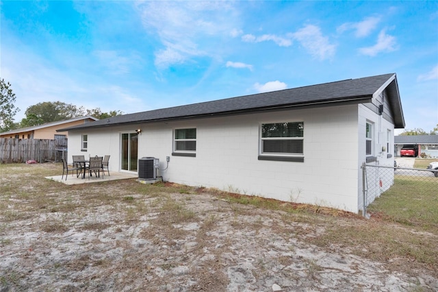 rear view of house featuring central AC and a patio area