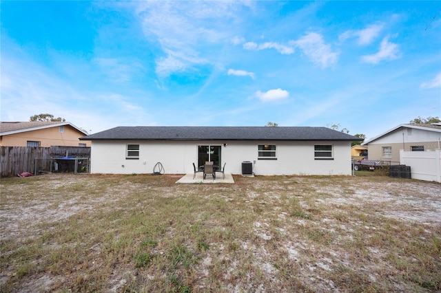 back of house with a patio, central AC, and a lawn