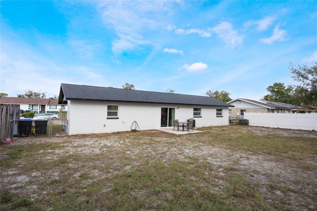 rear view of house with a patio area and a yard