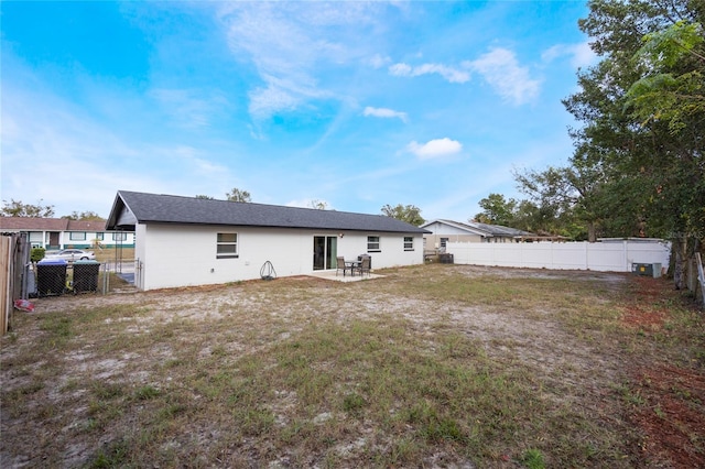 rear view of house featuring a yard and a patio