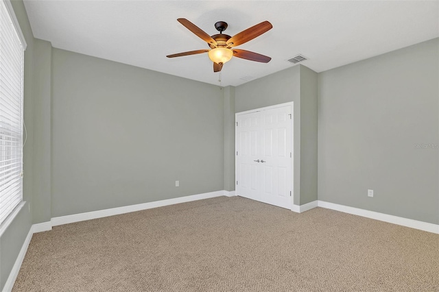 carpeted empty room with ceiling fan