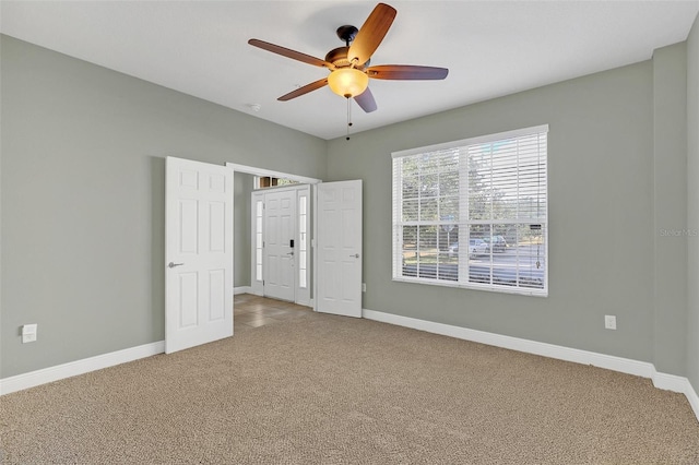 unfurnished bedroom featuring carpet floors and ceiling fan