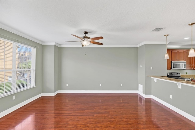 unfurnished living room featuring crown molding, ceiling fan, dark wood-type flooring, and a textured ceiling