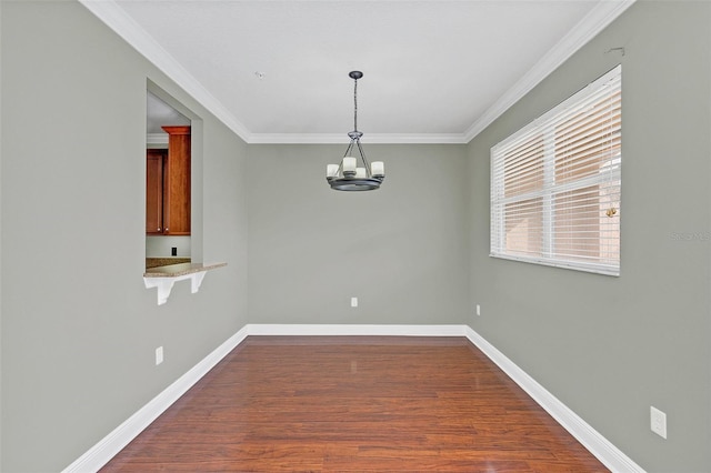 unfurnished dining area featuring hardwood / wood-style flooring, plenty of natural light, ornamental molding, and a chandelier