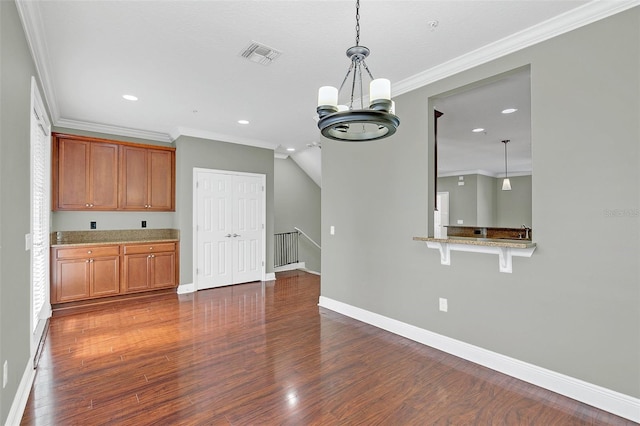 interior space with dark hardwood / wood-style flooring, ornamental molding, hanging light fixtures, and a chandelier