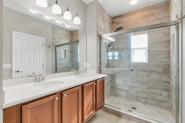 bathroom with tile patterned flooring, vanity, and an enclosed shower