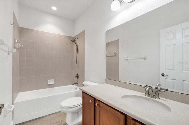 full bathroom featuring tile patterned flooring, vanity, tiled shower / bath combo, and toilet