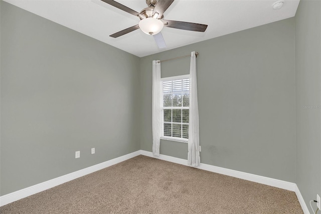 carpeted spare room featuring ceiling fan