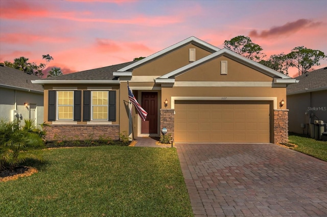 view of front of home featuring a lawn and a garage