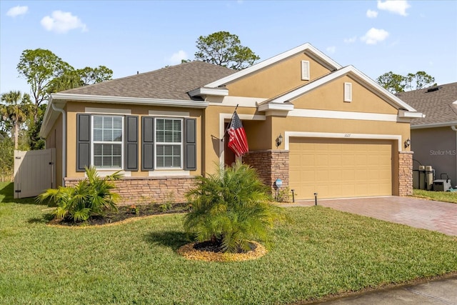 view of front of property with a front yard and a garage