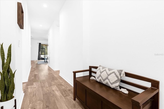 corridor with light hardwood / wood-style floors