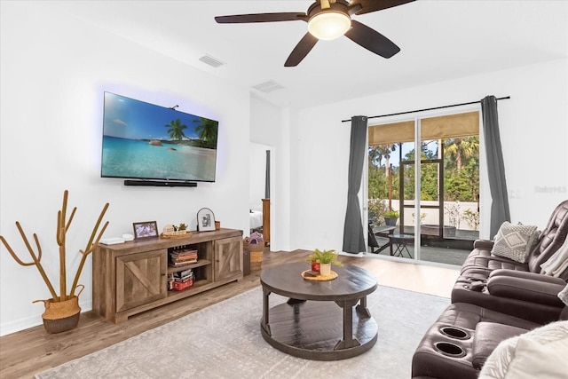 living room with hardwood / wood-style flooring and ceiling fan