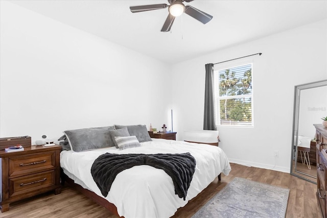 bedroom with hardwood / wood-style floors and ceiling fan