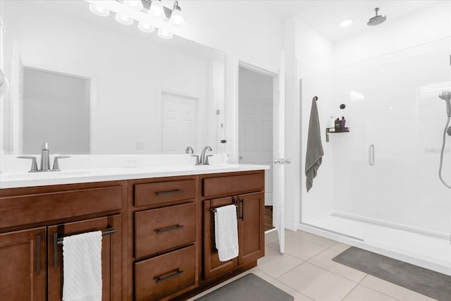 bathroom featuring tile patterned flooring, vanity, and a shower with shower door