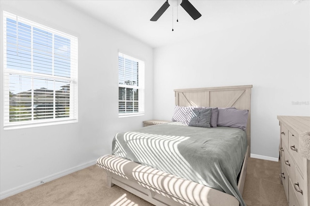 bedroom featuring light colored carpet and ceiling fan