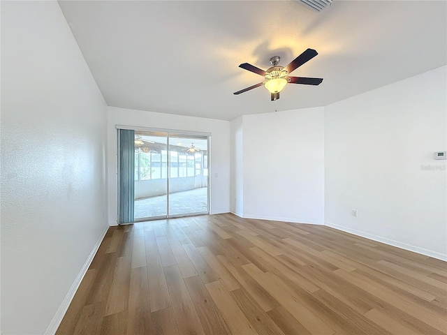 empty room with ceiling fan and light hardwood / wood-style flooring