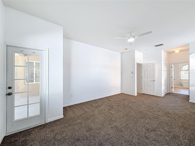 carpeted spare room featuring ceiling fan