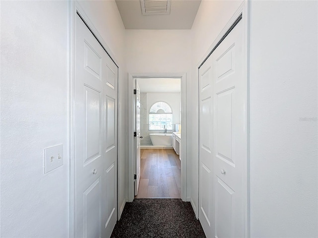 corridor featuring hardwood / wood-style floors