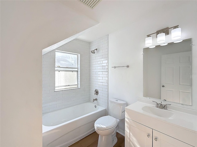 full bathroom featuring vanity, toilet, and tiled shower / bath combo