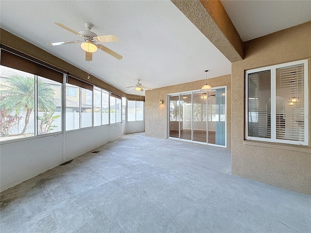 unfurnished sunroom featuring ceiling fan and a water view