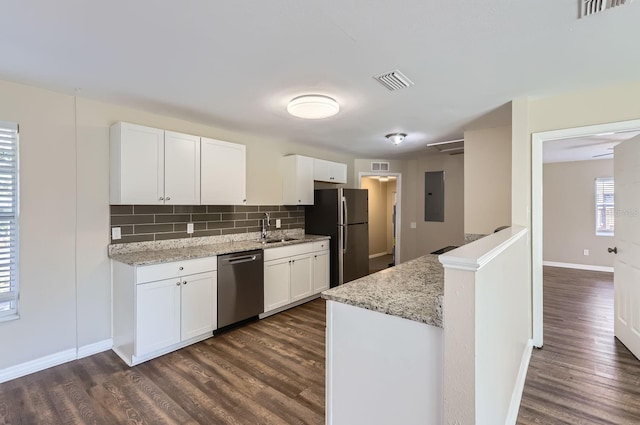 kitchen featuring stainless steel appliances, sink, white cabinetry, decorative backsplash, and light stone countertops