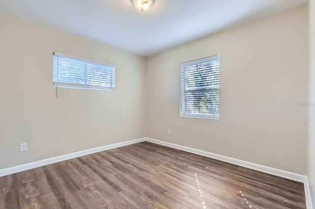 empty room featuring dark hardwood / wood-style flooring