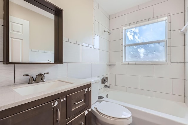 full bathroom with tile walls, toilet, decorative backsplash, vanity, and tiled shower / bath combo