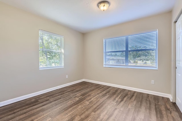 unfurnished room featuring dark hardwood / wood-style floors