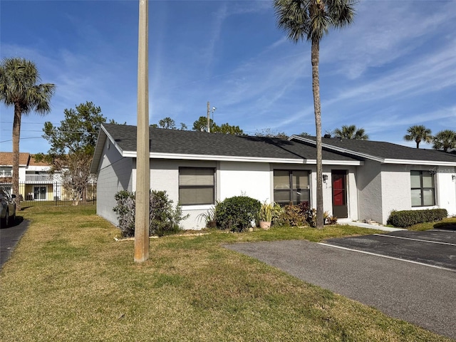 single story home featuring a front lawn