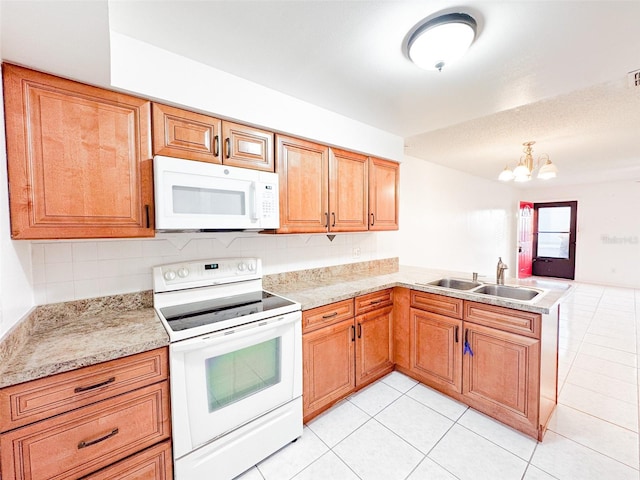 kitchen featuring sink, a notable chandelier, kitchen peninsula, white appliances, and light tile patterned floors