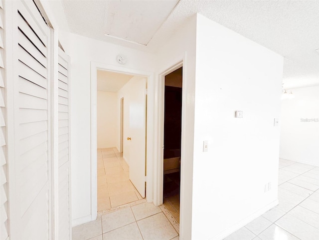 corridor with light tile patterned floors