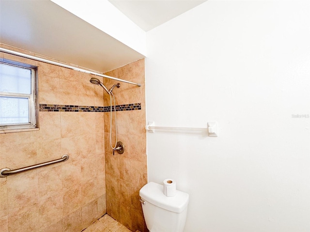 bathroom featuring toilet and a tile shower