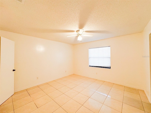 tiled empty room with a textured ceiling and ceiling fan