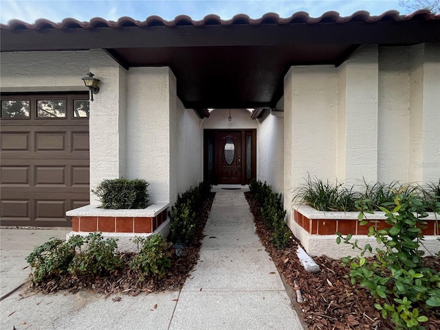 doorway to property with a garage