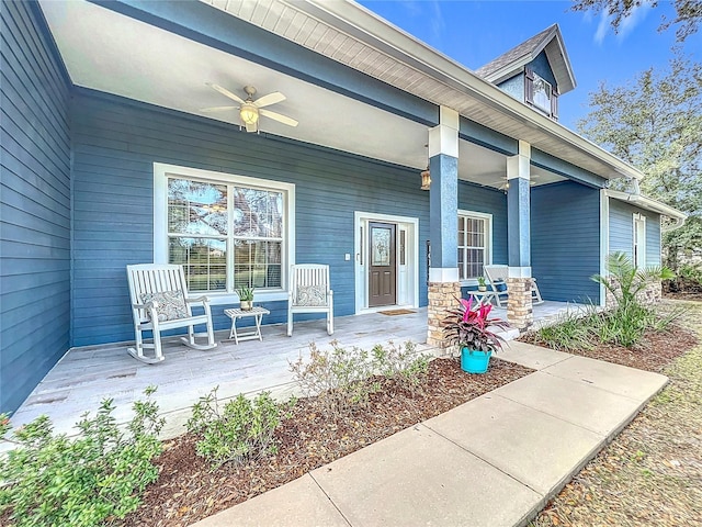 entrance to property featuring ceiling fan and covered porch