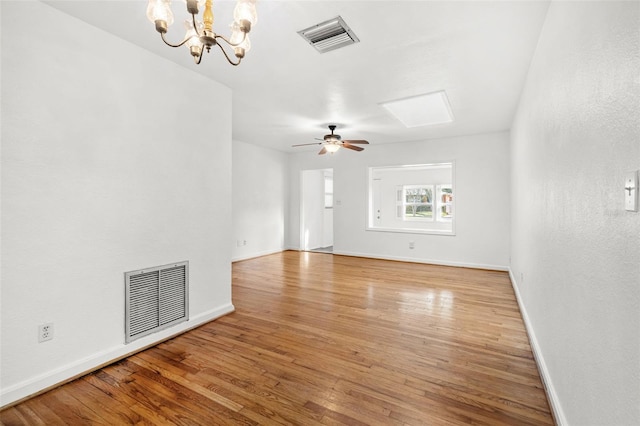 unfurnished living room featuring light hardwood / wood-style flooring and ceiling fan with notable chandelier