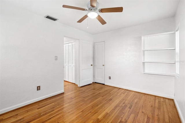 unfurnished room with light wood-type flooring and ceiling fan