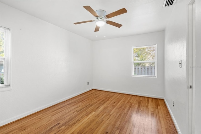 empty room with ceiling fan and light wood-type flooring