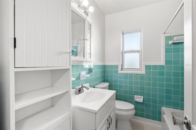 full bathroom with shower / tub combination, vanity, tile walls, and toilet